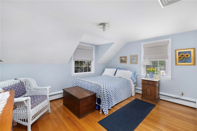 221 Trinity St, Warwick, RI 02886 - bedroom featuring a baseboard radiator, wood finished floors, multiple windows, and vaulted ceiling