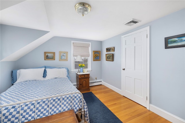 221 Trinity St, Warwick, RI 02886 - bedroom with baseboard heating and light wood-style flooring