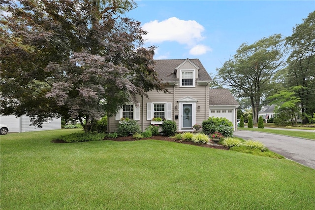 221 Trinity St, Warwick, RI 02886 - view of front of property with a front lawn, an attached garage, driveway, and a shingled roof