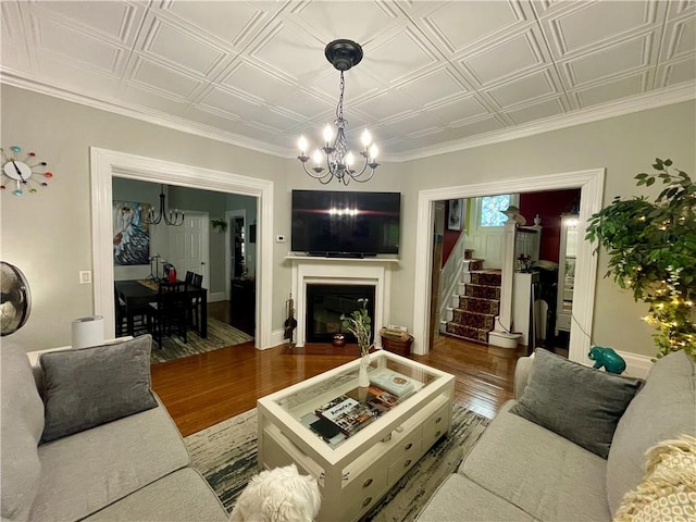 113 Alger Ave, Providence, RI 02905 - living area with a chandelier, wood finished floors, an ornate ceiling, stairs, and a glass covered fireplace