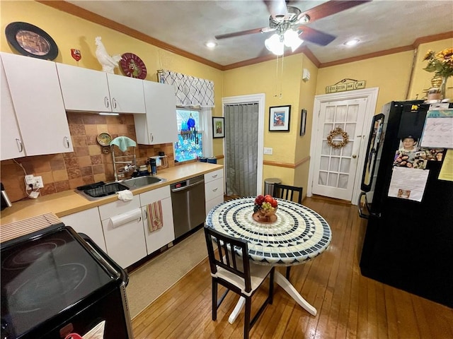 113 Alger Ave, Providence, RI 02905 - kitchen featuring black appliances, hardwood / wood-style floors, white cabinetry, light countertops, and ornamental molding