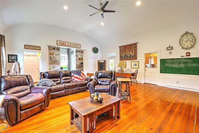 53 Avon St, Somerset, MA 02726 - living room with vaulted ceiling, light wood finished floors, a ceiling fan, baseboard heating, and built in features