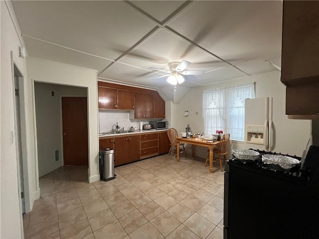 12 Winthrop St, Cranston, RI 02910 - kitchen with a ceiling fan, light countertops, stainless steel microwave, white fridge with ice dispenser, and light tile patterned floors