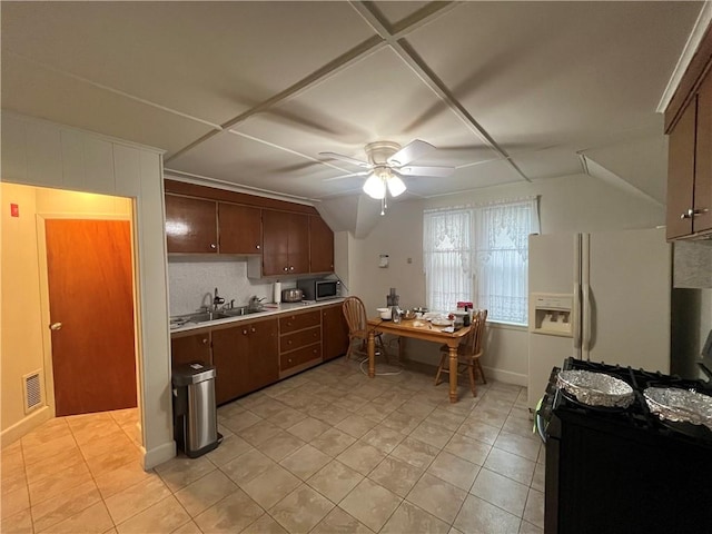 12 Winthrop St, Cranston, RI 02910 - kitchen featuring ceiling fan, appliances with stainless steel finishes, light countertops, light tile patterned floors, and vaulted ceiling