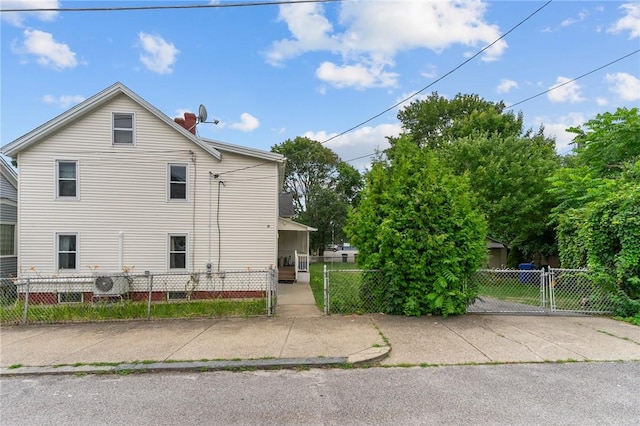 10 Foundry St, Central Falls, RI 02863 - view of side of property featuring a gate and a chimney