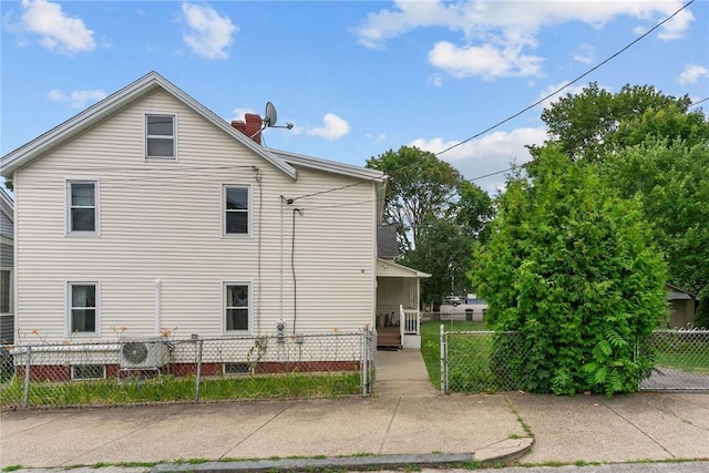 10 Foundry St, Central Falls, RI 02863 - rear view of house featuring a chimney