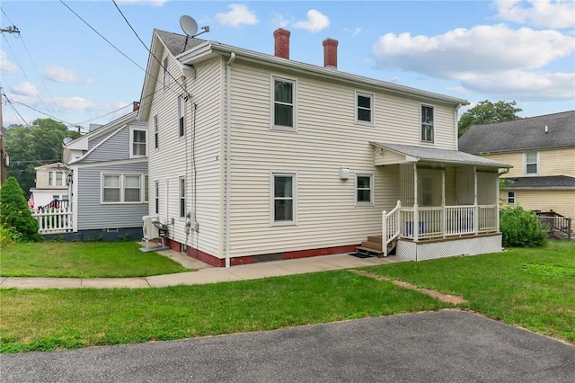 10 Foundry St, Central Falls, RI 02863 - back of house with a chimney and a lawn