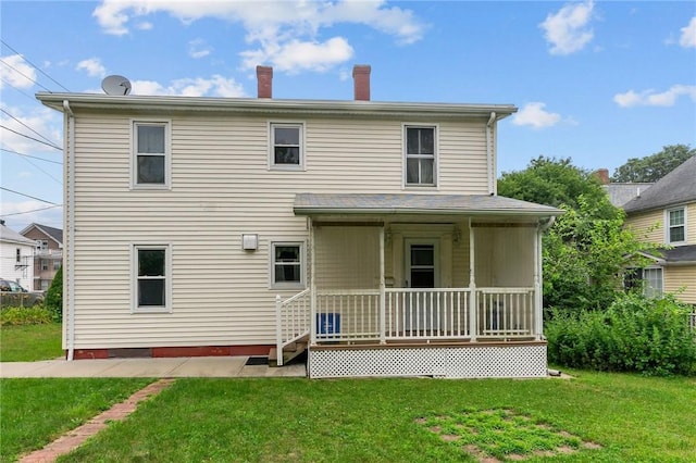 10 Foundry St, Central Falls, RI 02863 - back of house featuring covered porch and a yard