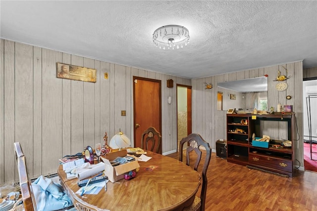 10 Foundry St, Central Falls, RI 02863 - dining room with wood finished floors, a textured ceiling, and wood walls