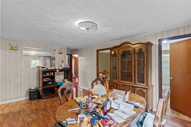 10 Foundry St, Central Falls, RI 02863 - dining room with wood finished floors, a textured ceiling, and wood walls