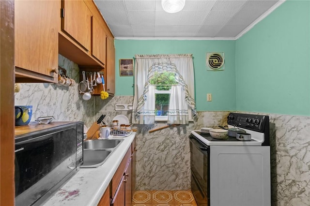 10 Foundry St, Central Falls, RI 02863 - kitchen featuring black appliances, brown cabinets, crown molding, wainscoting, and light countertops