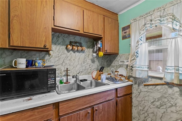 10 Foundry St, Central Falls, RI 02863 - kitchen with black microwave, backsplash, light countertops, and brown cabinetry
