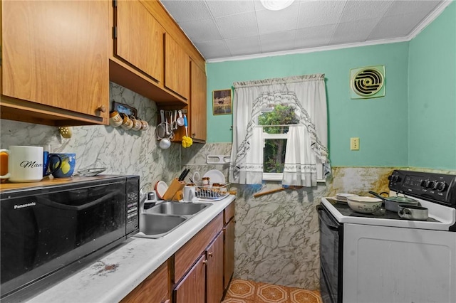 10 Foundry St, Central Falls, RI 02863 - kitchen featuring white electric stove, black microwave, brown cabinetry, crown molding, and light countertops