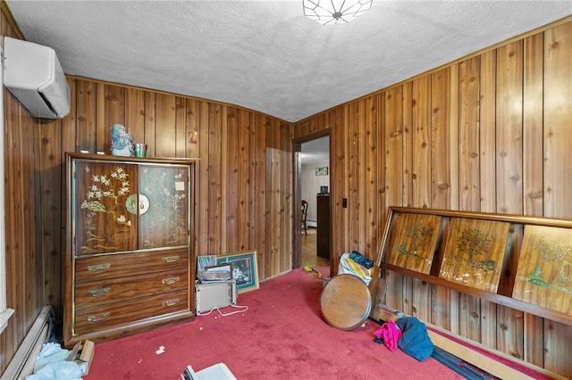 10 Foundry St, Central Falls, RI 02863 - carpeted bedroom featuring an AC wall unit, baseboard heating, a textured ceiling, and wooden walls