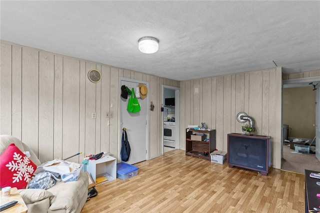 10 Foundry St, Central Falls, RI 02863 - living area featuring wood finished floors, wooden walls, and a textured ceiling