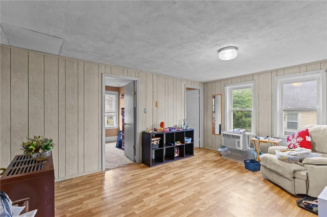 10 Foundry St, Central Falls, RI 02863 - living room with wood finished floors, wooden walls, and a textured ceiling