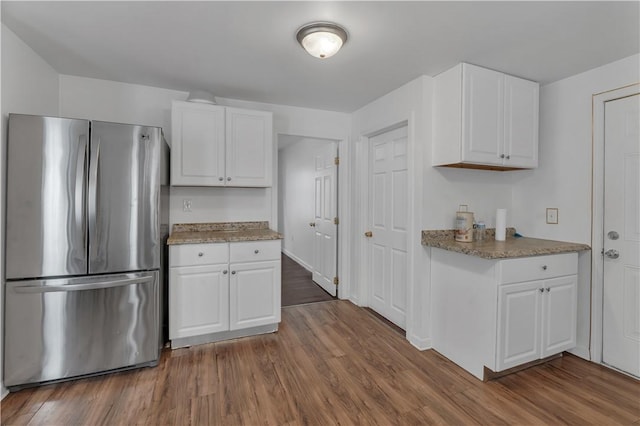 1 Ware St, Providence, RI 02907 - kitchen with freestanding refrigerator, white cabinets, and dark wood-style floors