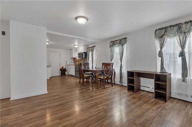 1 Ware St, Providence, RI 02907 - dining area featuring a baseboard heating unit and wood finished floors