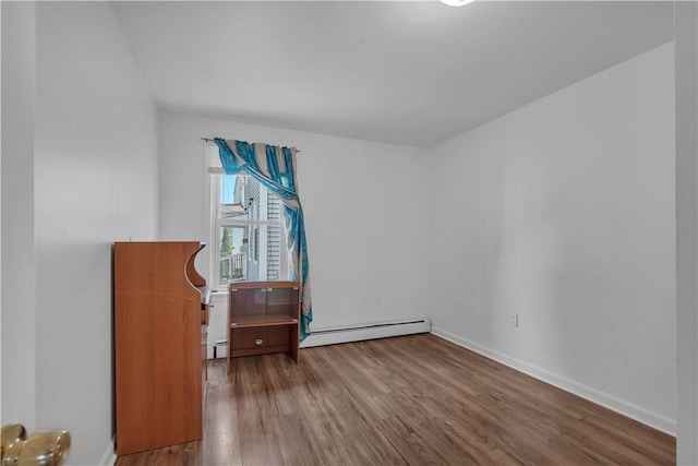 1 Ware St, Providence, RI 02907 - empty room featuring wood finished floors and a baseboard radiator