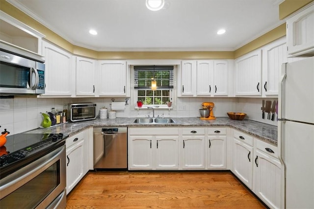 825 Matteson Rd, Coventry, RI 02816 - kitchen with appliances with stainless steel finishes, white cabinetry, tasteful backsplash, crown molding, and light wood finished floors