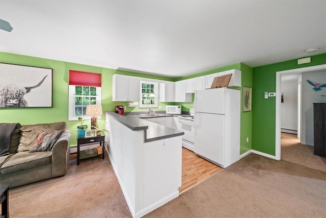 825 Matteson Rd, Coventry, RI 02816 - kitchen featuring white appliances, light carpet, a peninsula, a baseboard radiator, and white cabinets