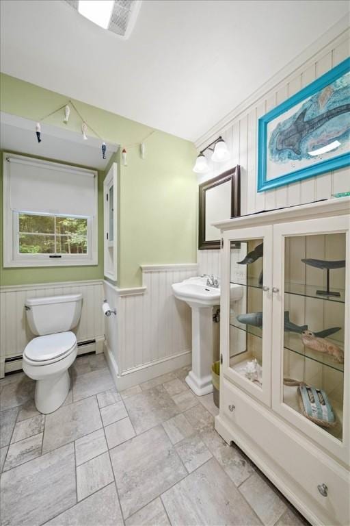 825 Matteson Rd, Coventry, RI 02816 - bathroom featuring wainscoting and a baseboard heating unit