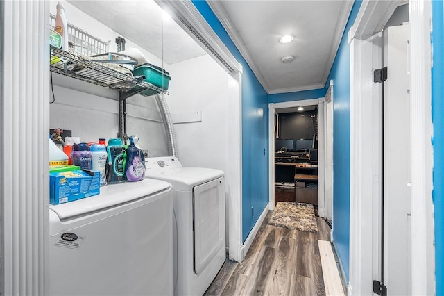 18 Magnolia Ln, Coventry, RI 02816 - laundry room featuring wood finished floors, washing machine and dryer, and ornamental molding