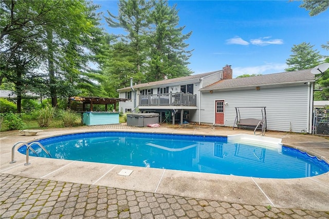 18 Magnolia Ln, Coventry, RI 02816 - outdoor pool with a hot tub, a deck, and a pergola