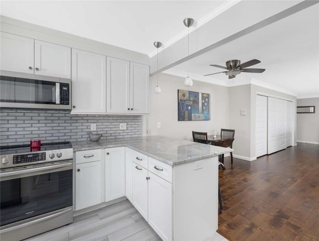 400 Narragansett Pkwy Unit Sb9, Warwick, RI 02888 - kitchen with appliances with stainless steel finishes, ornamental molding, a peninsula, decorative backsplash, and ceiling fan