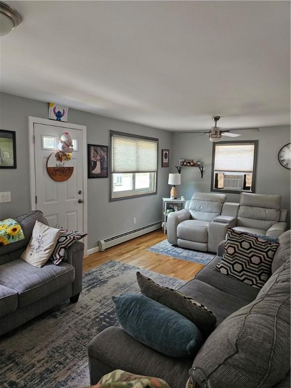 250 Arnold Rd, Coventry, RI 02816 - living area featuring a baseboard heating unit, cooling unit, light wood-style flooring, and ceiling fan