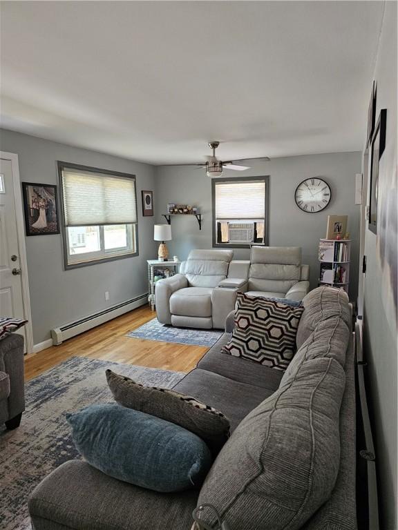 250 Arnold Rd, Coventry, RI 02816 - living room with a baseboard heating unit, plenty of natural light, a ceiling fan, and light wood-style floors