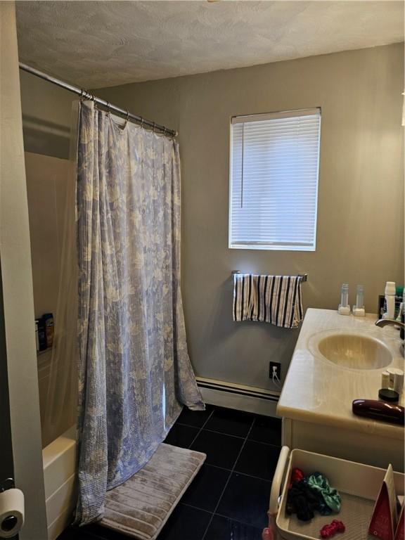 250 Arnold Rd, Coventry, RI 02816 - full bathroom featuring a baseboard radiator, tile patterned floors, shower / tub combo, and vanity