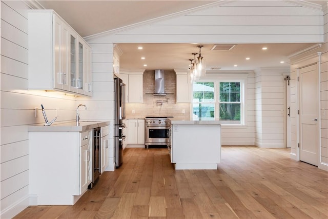 5 Williams St Unit 4, Warwick, RI 02818 - kitchen featuring stainless steel appliances, wall chimney exhaust hood, light countertops, light wood-style flooring, and recessed lighting