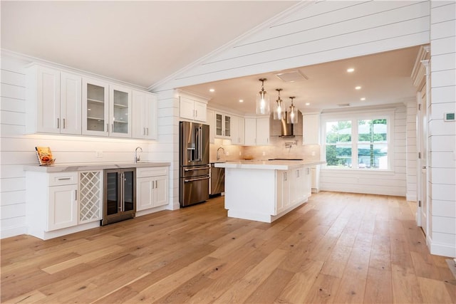 5 Williams St Unit 4, Warwick, RI 02818 - kitchen featuring high end refrigerator, wine cooler, wall chimney range hood, light countertops, and white cabinets