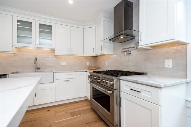 5 Williams St Unit 4, Warwick, RI 02818 - kitchen featuring high end stainless steel range, wall chimney exhaust hood, and white cabinetry