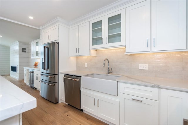 5 Williams St Unit 4, Warwick, RI 02818 - kitchen with appliances with stainless steel finishes, white cabinets, light wood-style floors, glass insert cabinets, and light stone counters