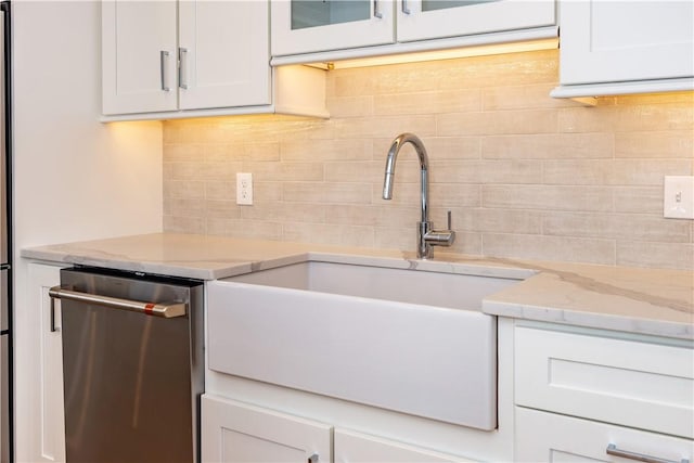 5 Williams St Unit 4, Warwick, RI 02818 - kitchen with dishwasher, backsplash, white cabinets, light stone counters, and glass insert cabinets