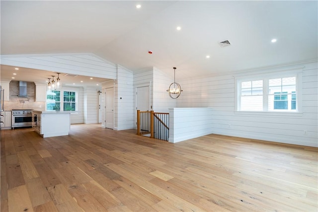 5 Williams St Unit 4, Warwick, RI 02818 - unfurnished living room with a chandelier, hardwood / wood-style flooring, lofted ceiling, wooden walls, and recessed lighting