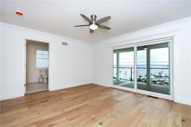 5 Williams St Unit 4, Warwick, RI 02818 - unfurnished room featuring light wood-style flooring, healthy amount of natural light, ornamental molding, ceiling fan, and a water view