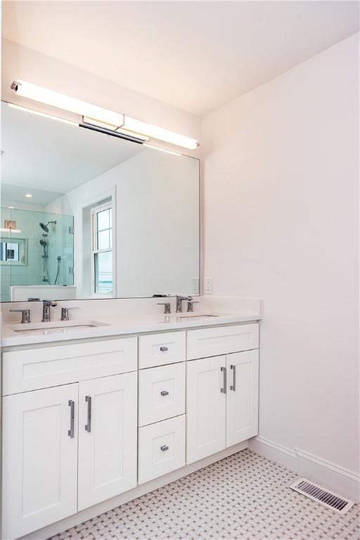 5 Williams St Unit 4, Warwick, RI 02818 - bathroom with a stall shower, double vanity, and tile patterned floors