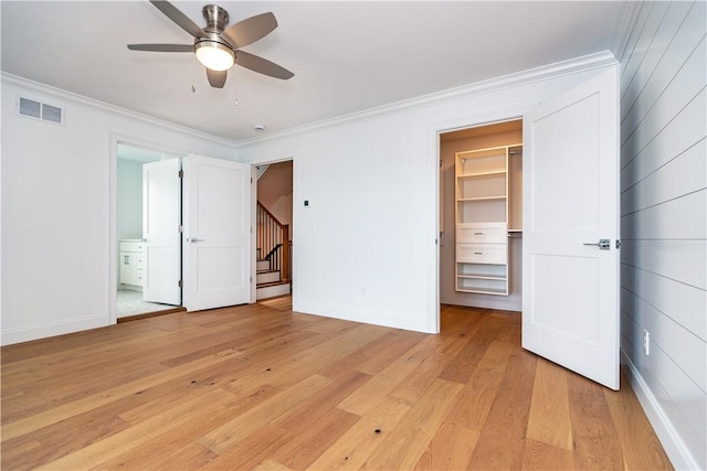 5 Williams St Unit 4, Warwick, RI 02818 - unfurnished bedroom featuring light wood finished floors, ornamental molding, a spacious closet, ensuite bathroom, and a ceiling fan