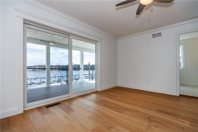 5 Williams St Unit 4, Warwick, RI 02818 - unfurnished room with light wood-style flooring, ceiling fan, ornamental molding, and a water view