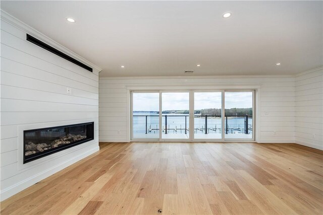 5 Williams St Unit 4, Warwick, RI 02818 - unfurnished living room with ornamental molding, a glass covered fireplace, plenty of natural light, light wood-style floors, and recessed lighting