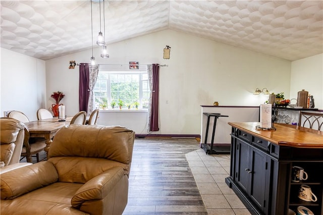 61 Cyr St, Providence, RI 02905 - living area featuring vaulted ceiling, light wood finished floors, and a textured ceiling