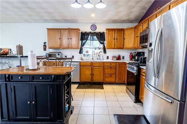 61 Cyr St, Providence, RI 02905 - kitchen with stainless steel appliances, brown cabinets, backsplash, light tile patterned flooring, and open shelves