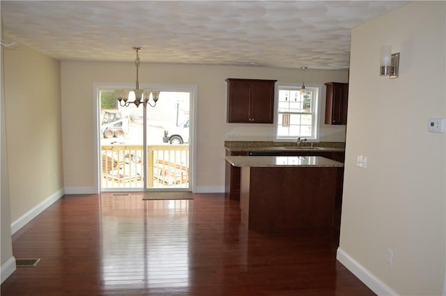 75 Esmond St Unit 5D, West Warwick, RI 02893 - kitchen with a chandelier, dark wood finished floors, pendant lighting, and dark brown cabinetry