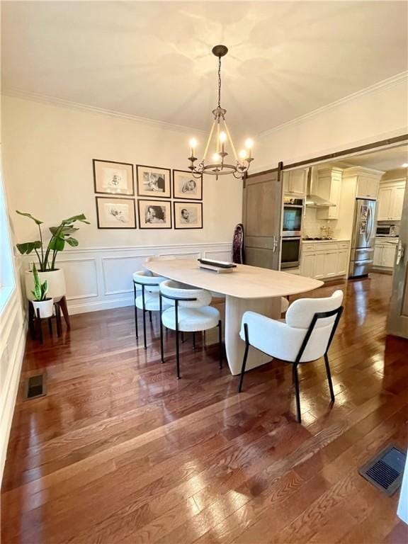 21 Helm St, Jamestown, RI 02835 - dining room featuring a chandelier, crown molding, dark wood-style flooring, a barn door, and a decorative wall