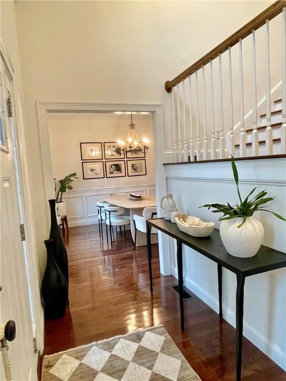 21 Helm St, Jamestown, RI 02835 - entryway with wood finished floors, a chandelier, a high ceiling, and a decorative wall