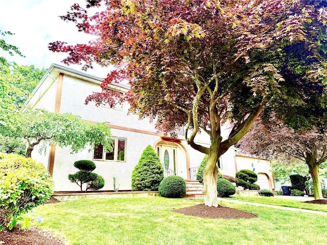 74 Plymouth Rd, East Providence, RI 02914 - view of front of home featuring stucco siding and a front lawn