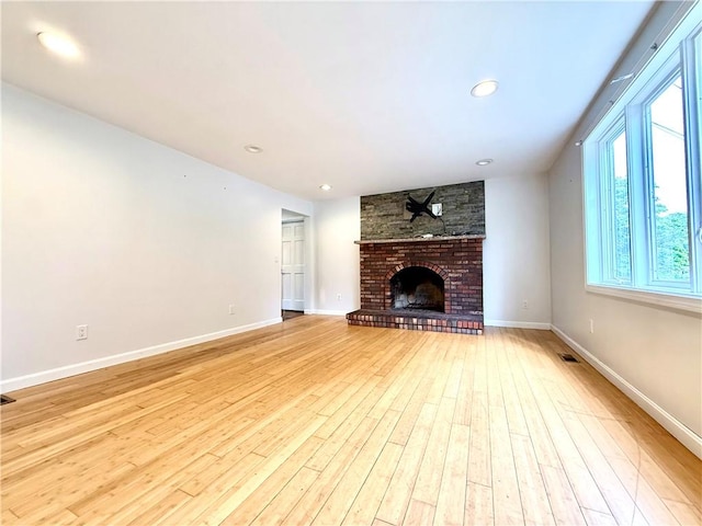 74 Plymouth Rd, East Providence, RI 02914 - unfurnished living room with healthy amount of natural light, wood finished floors, a fireplace, and recessed lighting